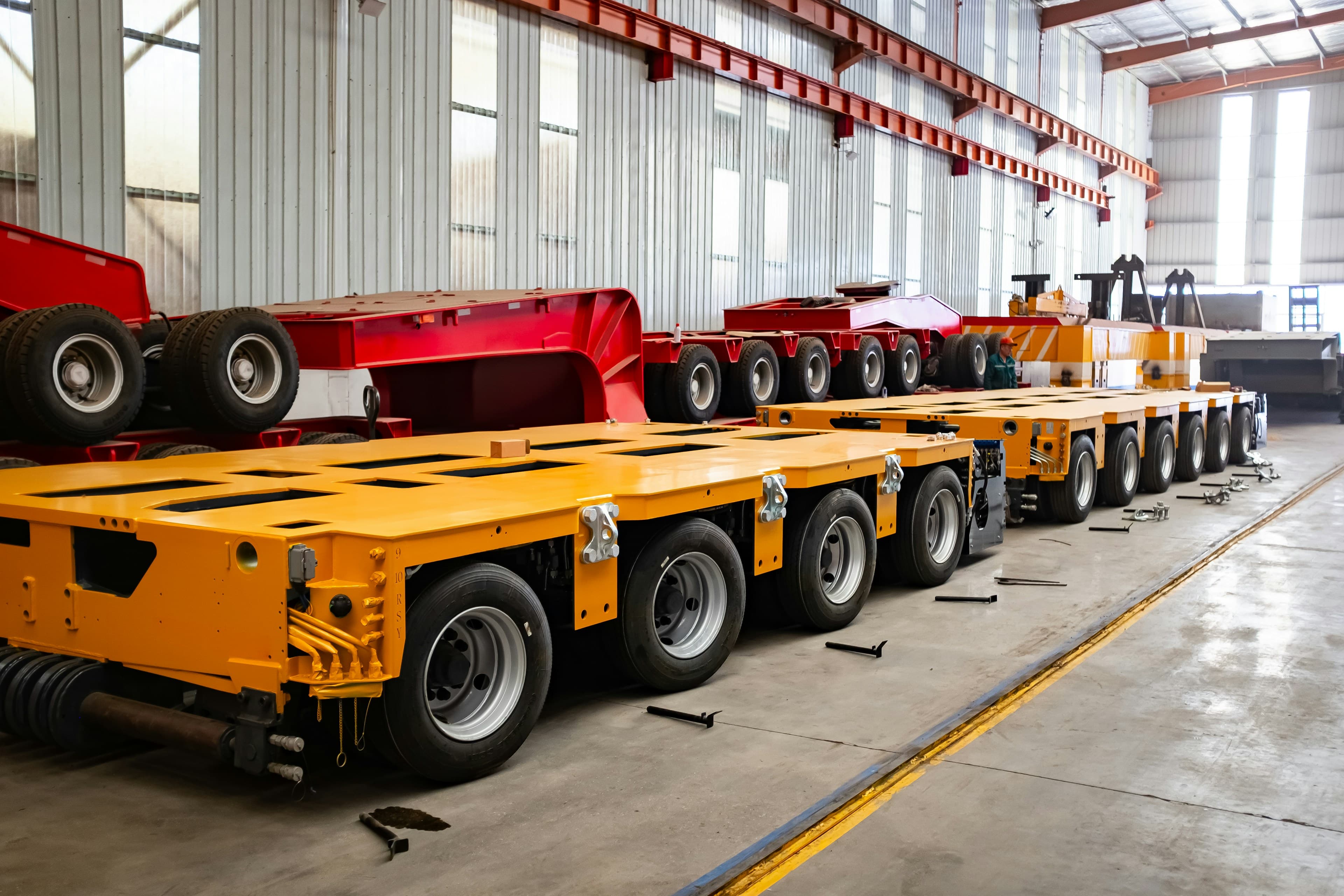 Lowbed trailers inside a manufacturing facility